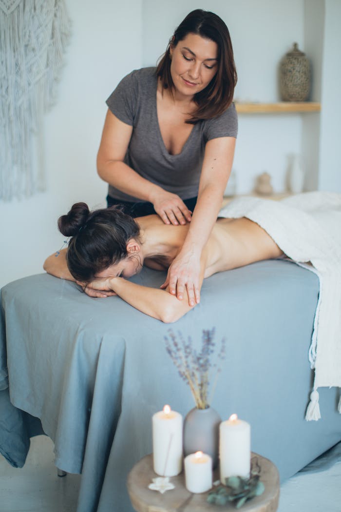 services-03 A serene spa setting with a therapist giving a back massage to a female client for relaxation.